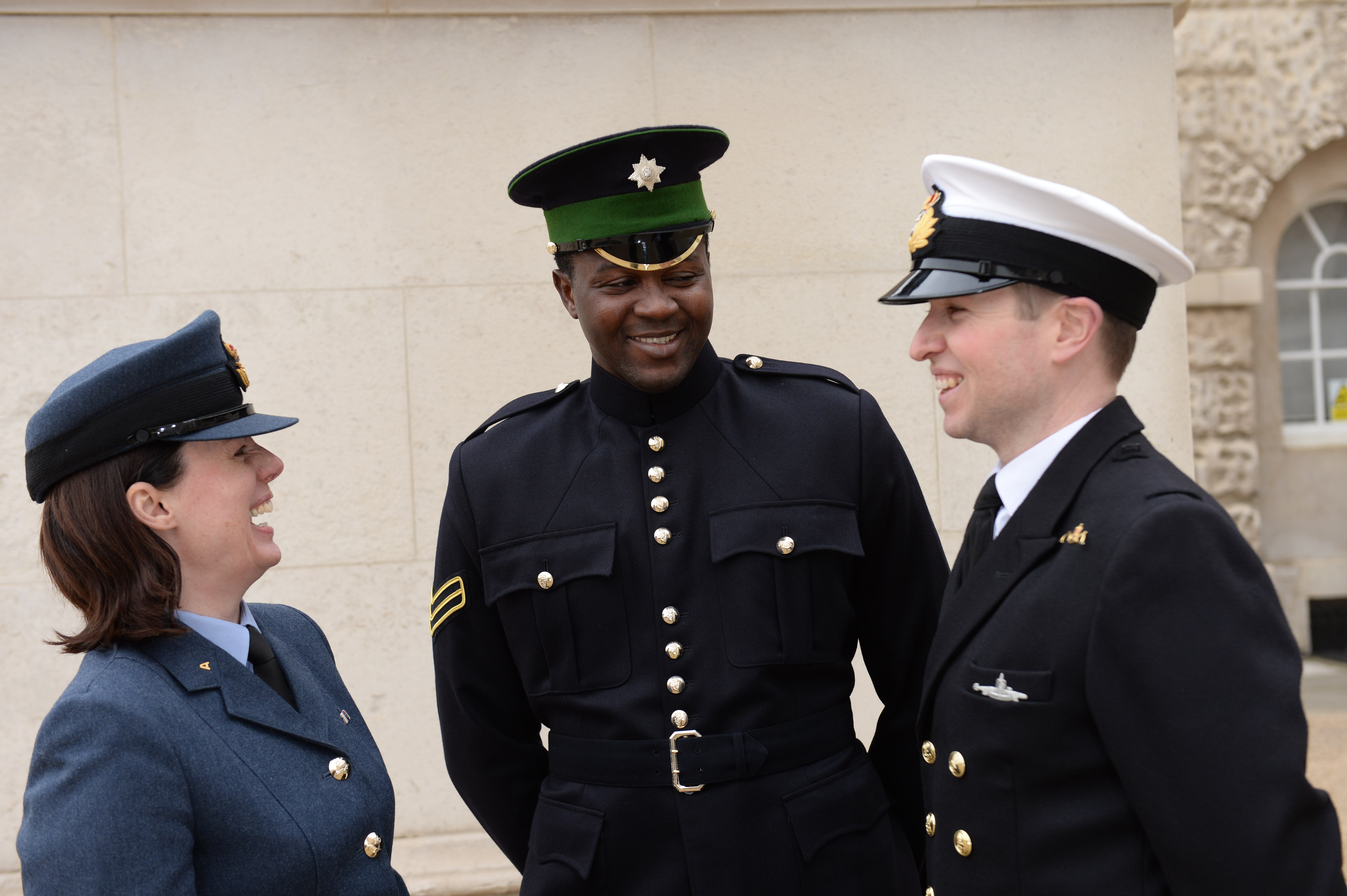 Reserves from the Royal Navy, British Army, Royal Air Force laughing together