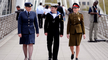 From left, a Royal Air Force servicewoman, a Royal Navy sailor and an Army soldier stroll thorugh London prior to Armed Forces Day 1010.