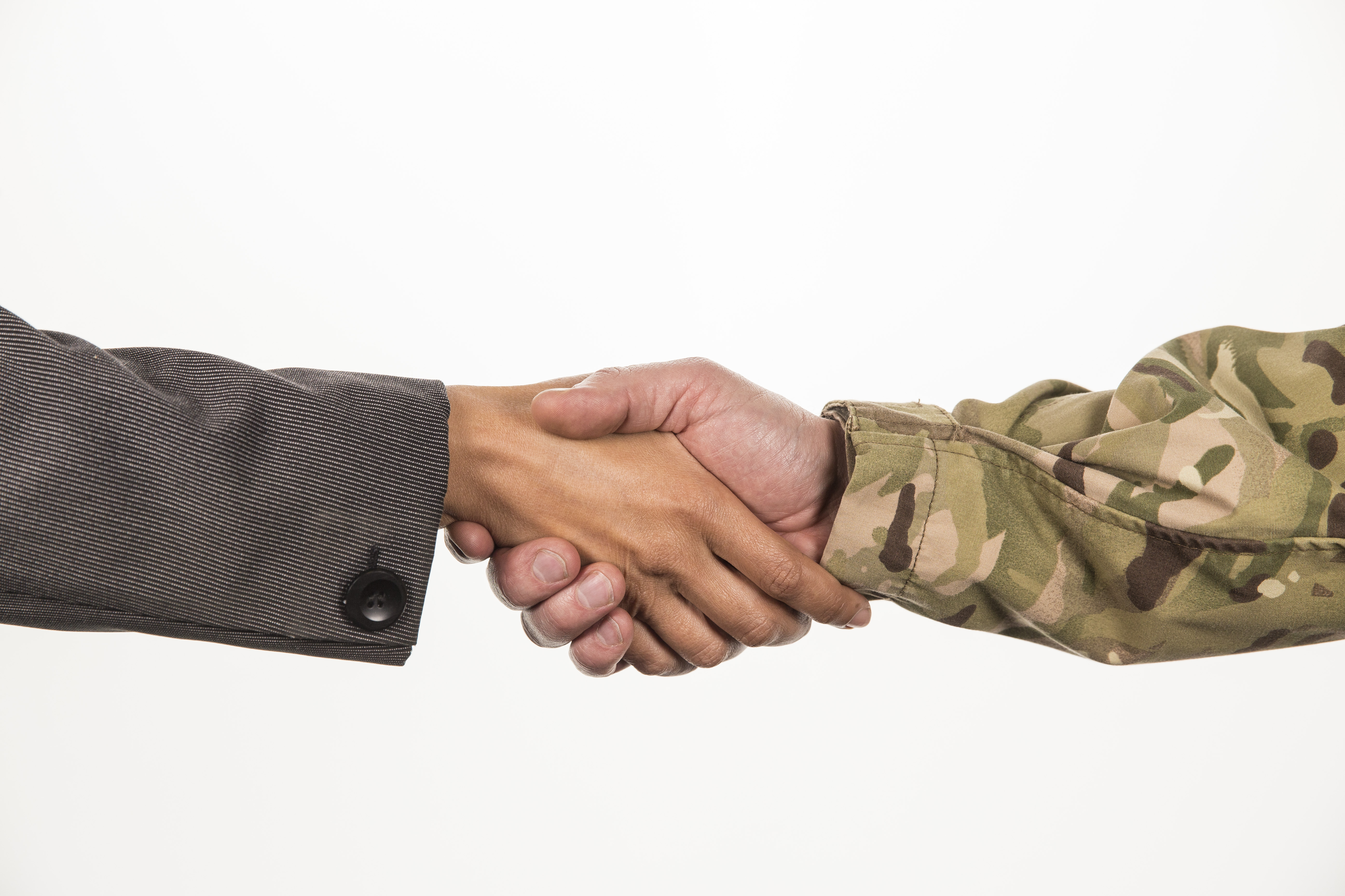 Close up of handshake between businesswoman and soldier wearing camouflage