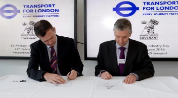 Mark Lancaster MP, and Mike Brown, Transport Commissioner, sign the Armed Forces Covenant.