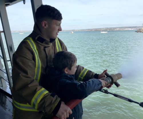 Pictured NFF Visit to HMS St Albans, playing with hoses. MOD Crown copyright. All rights reserved