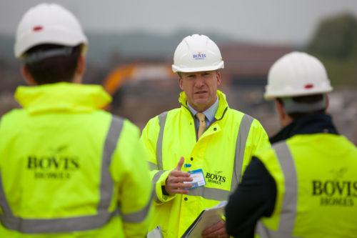 Bovis Homes employees in hardhats and florescent jackets. 