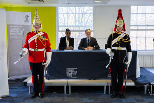 Image shows Minister for Defence People, Veterans and Service Families, Dr Andrew Murrison and John Lewis Chairman, Sharon White, signing the Armed Forces Covenant document.